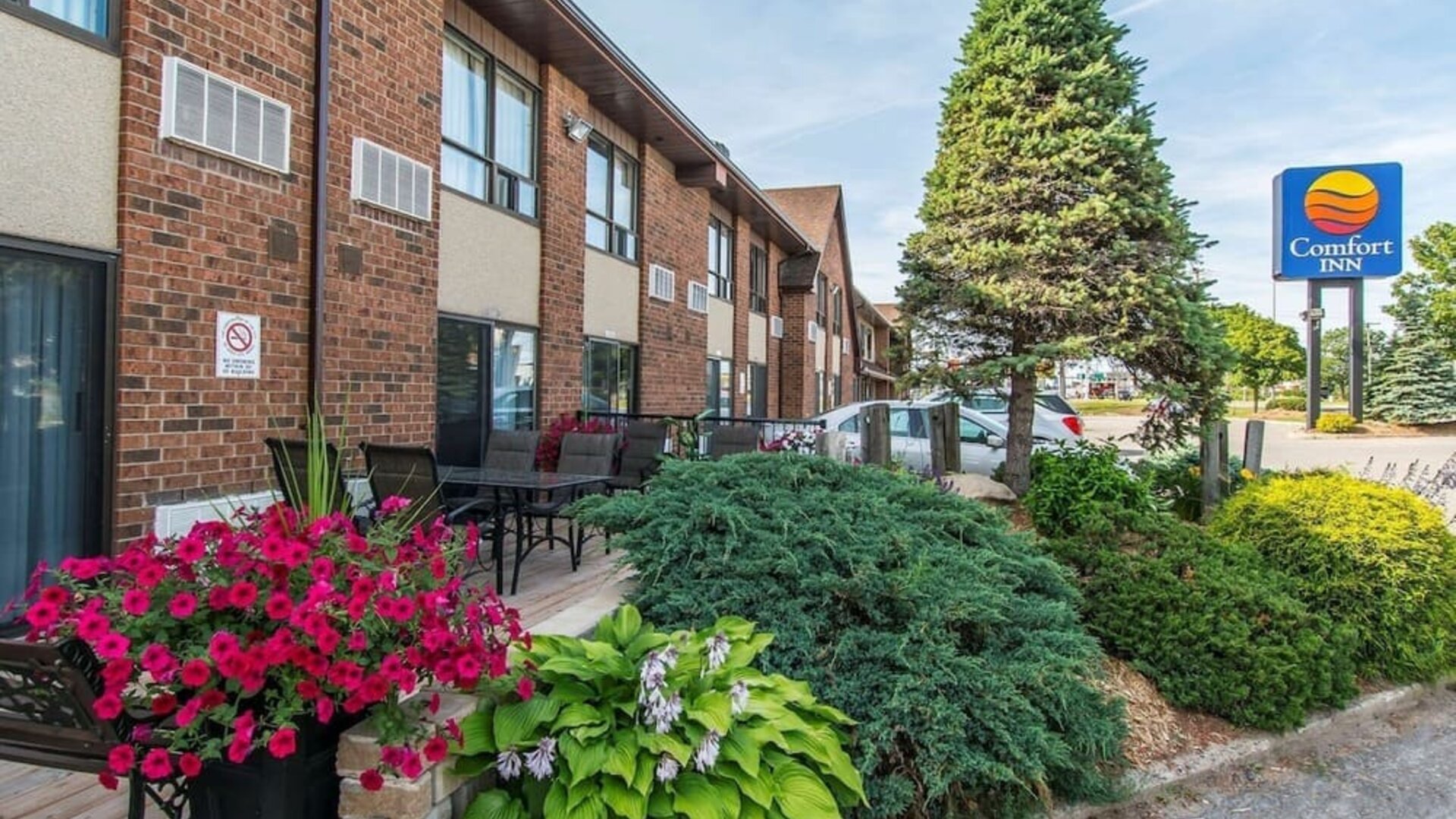 Hotel exterior with beautiful sitting area at Comfort Inn Sault Ste. Marie.