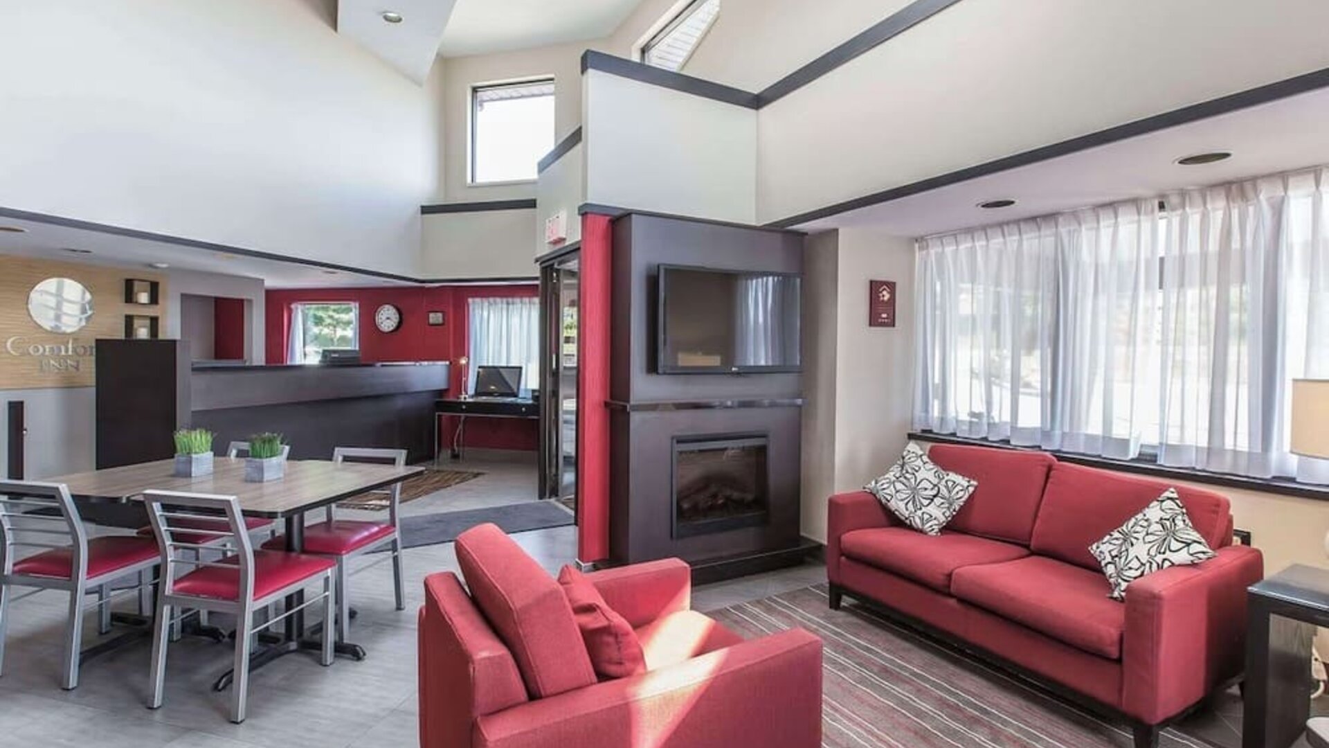 Lobby lounge with workspace and fireplace at Comfort Inn Sydney.