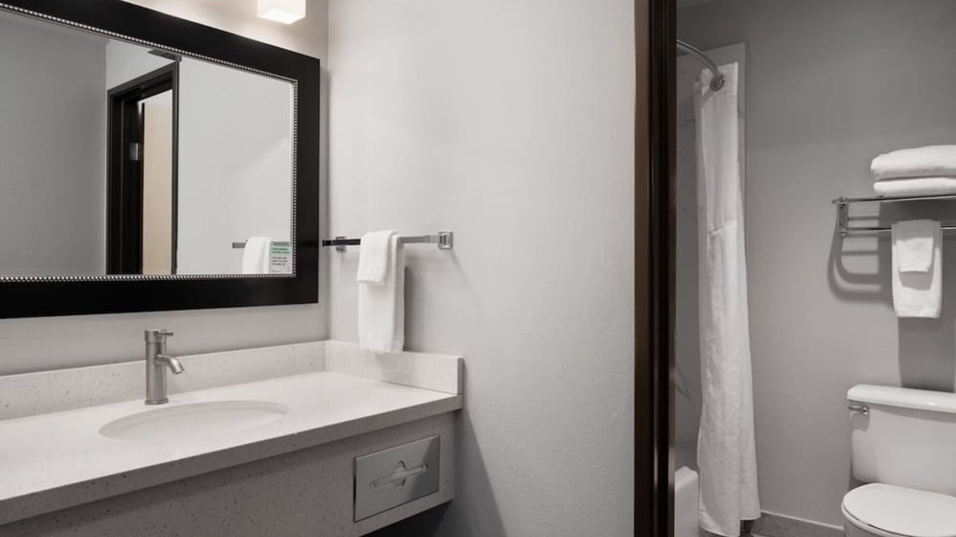 Guest bathroom with shower and tub at Garner By IHG.