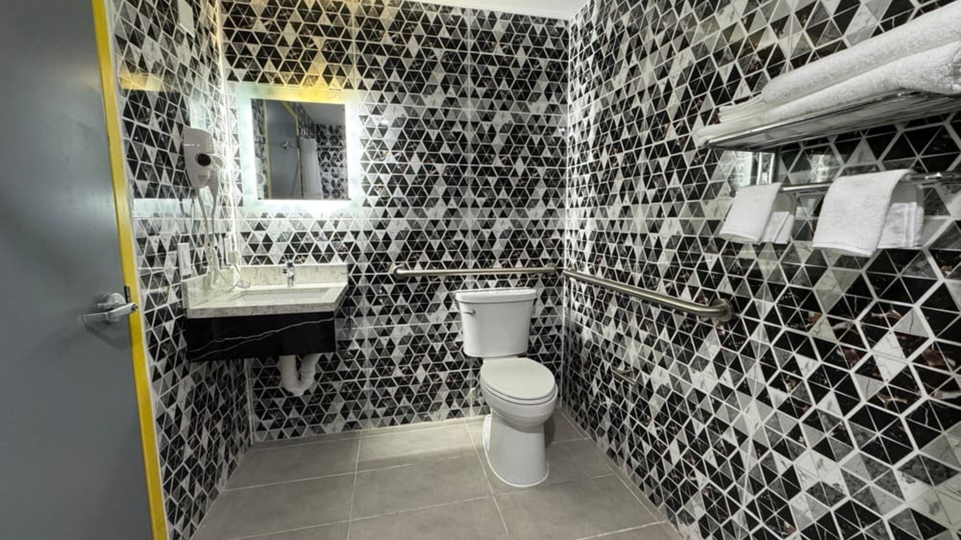 Bathroom with shower  at Days Inn Chinatown NYC.