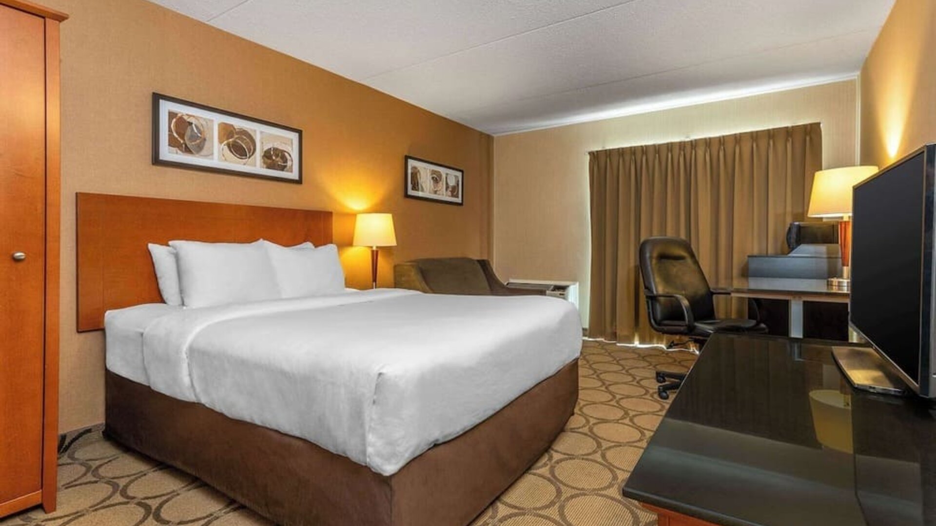 Standard day use room with TV, work desk and sofa at Comfort Inn Truro.