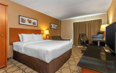 Standard day use room with TV, work desk and sofa at Comfort Inn Truro.