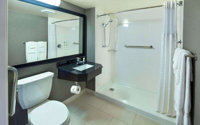 Guest bathroom with shower and free toiletries at Comfort Inn Moncton Magnetic Hill.