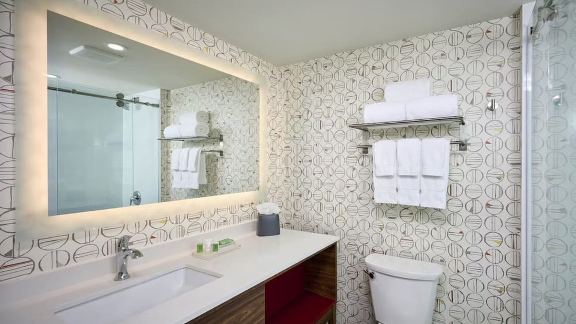Guest bathroom with shower and free toiletries at Holiday Inn & Suites Oakville At Bronte.