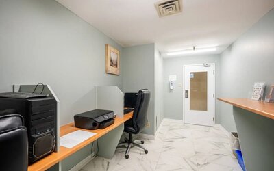 Business center with computers, printer and ergonomic chairs at Halifax Airport Hotel.