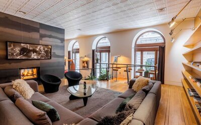 Lobby lounge with fireplace and workspace at Hotel Gault.