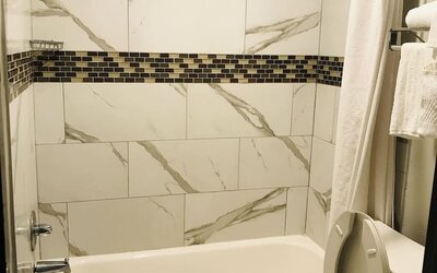 Guest bathroom with shower and tub at Summit Inn Near Houston Medical Center-NRG Park.