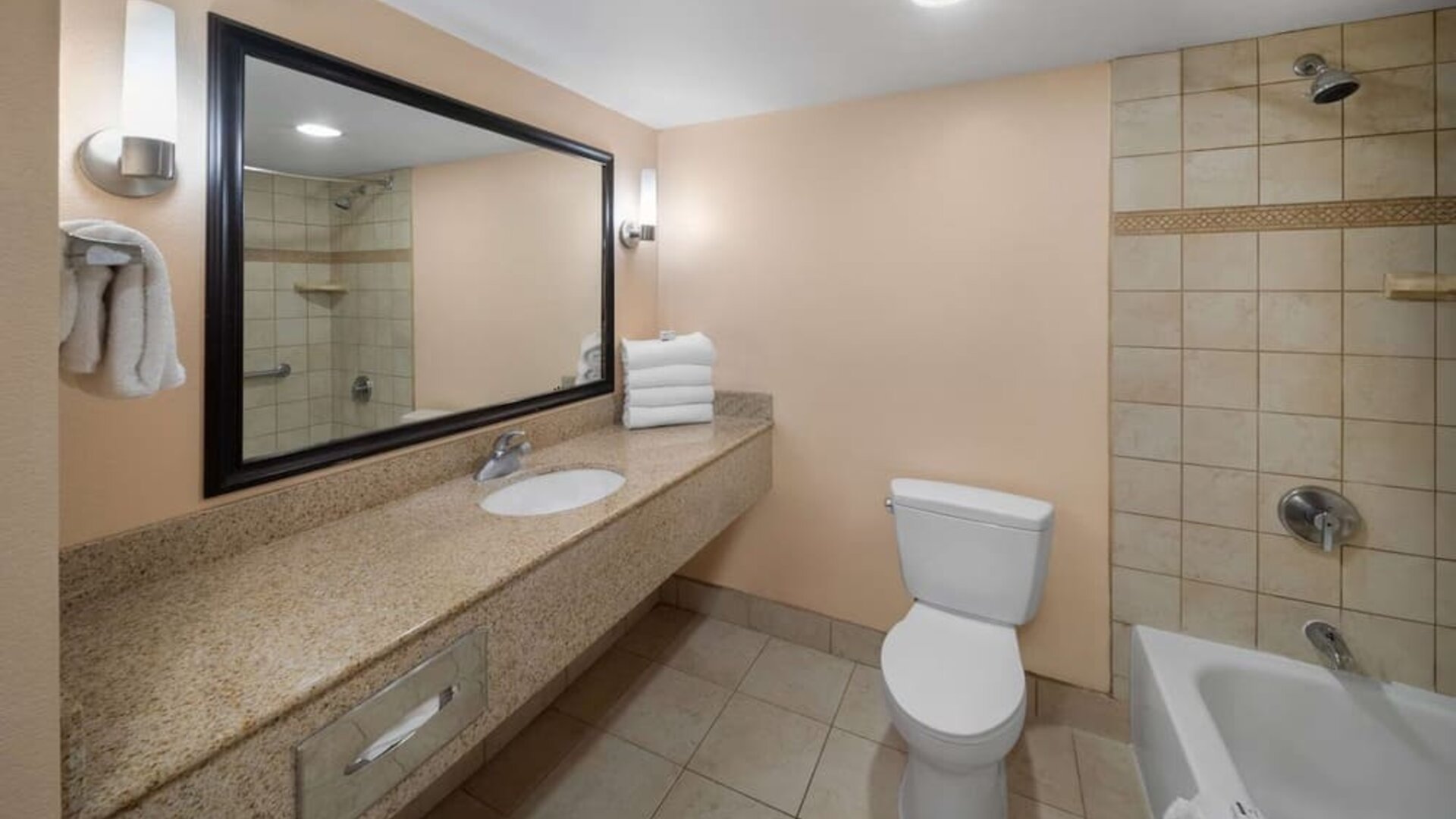 Guest bathroom with shower and tub at La Quinta Inn & Suites San Antonio Medical Center NW.
