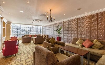 Bright and spacious lobby lounge with comfortable seating perfect for co-working at Thistle London Heathrow Terminal 5.