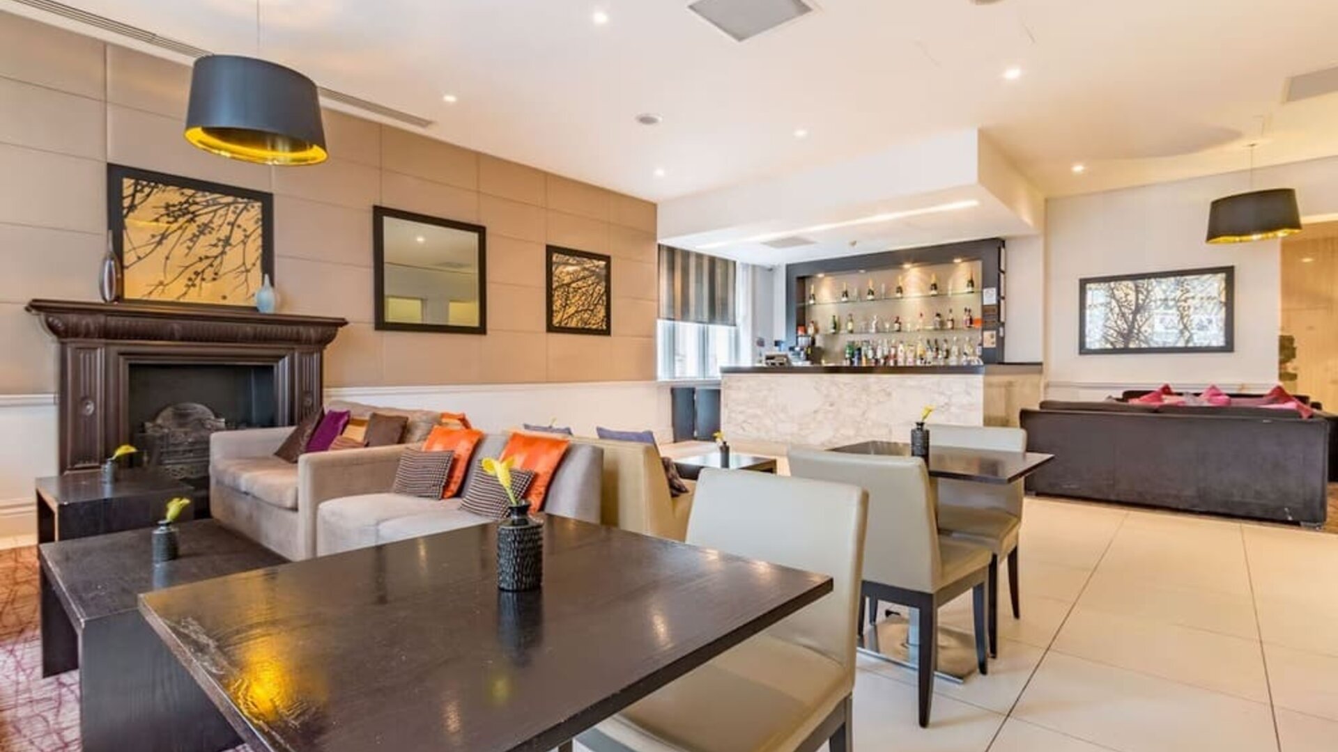 Hotel bar with comfortable seating and fireplace at Thistle Holborn, The Kingsley Hotel.