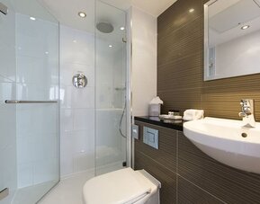 Guest bathroom with shower and free toiletries at Thistle Royal Trafalgar Square.