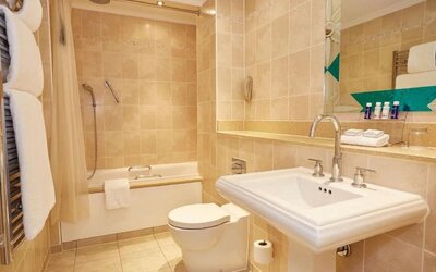 Guest bathroom with tub and free toiletries at The Royal Horseguards Hotel.