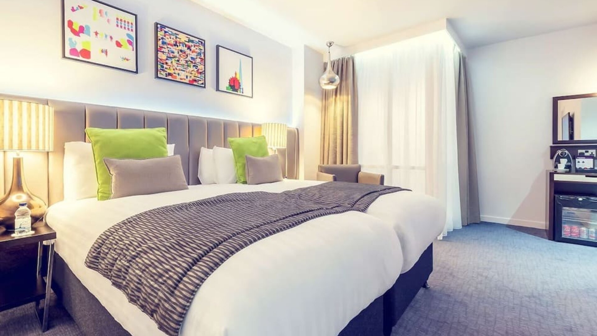 Bright and spacious day use twin room with work desk, sofa, mini bar and coffee maker at Mercure Hotel London Paddington.