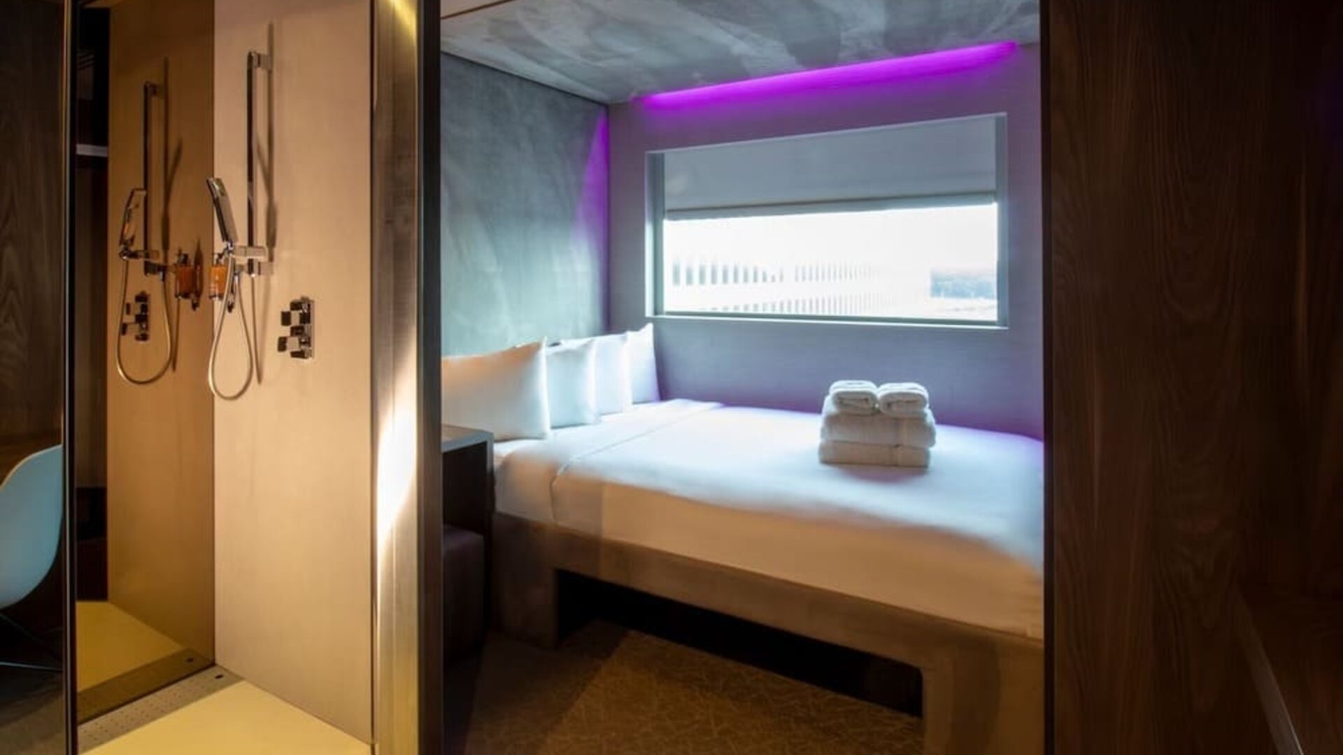 Day use room with work desk, private bathroom and window with view to the airport at Bloc Hotel.