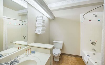 Guest bathroom with shower and tub at Hawthorn Suites By Wyndham El Paso Airport.