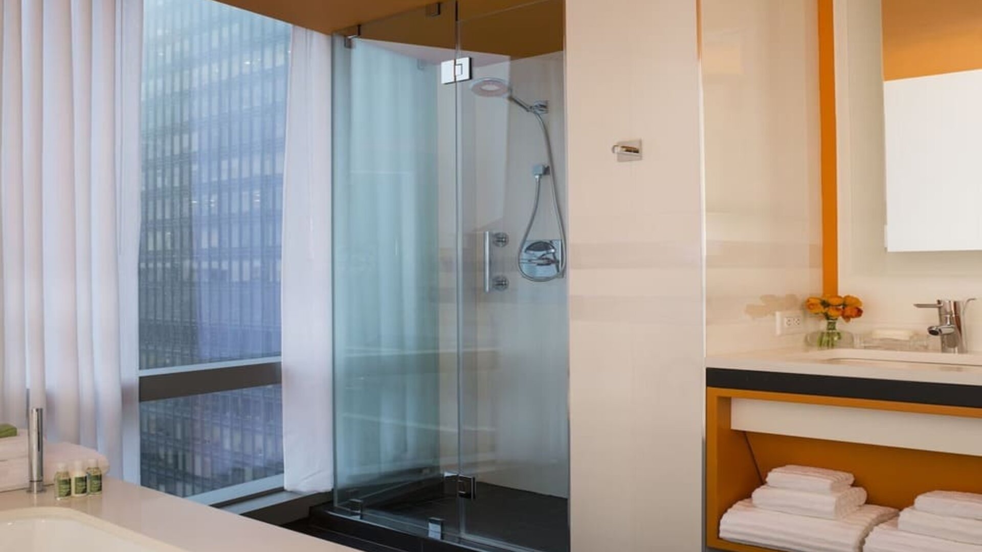 Guest bathroom with shower and tub at Courtyard By Marriott New York Manhattan/Central Park.