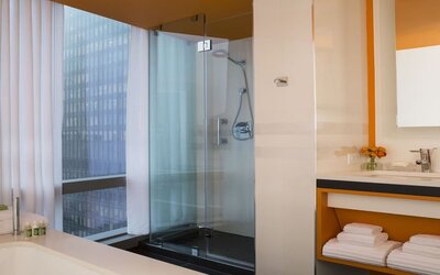 Guest bathroom with shower and tub at Courtyard By Marriott New York Manhattan/Central Park.