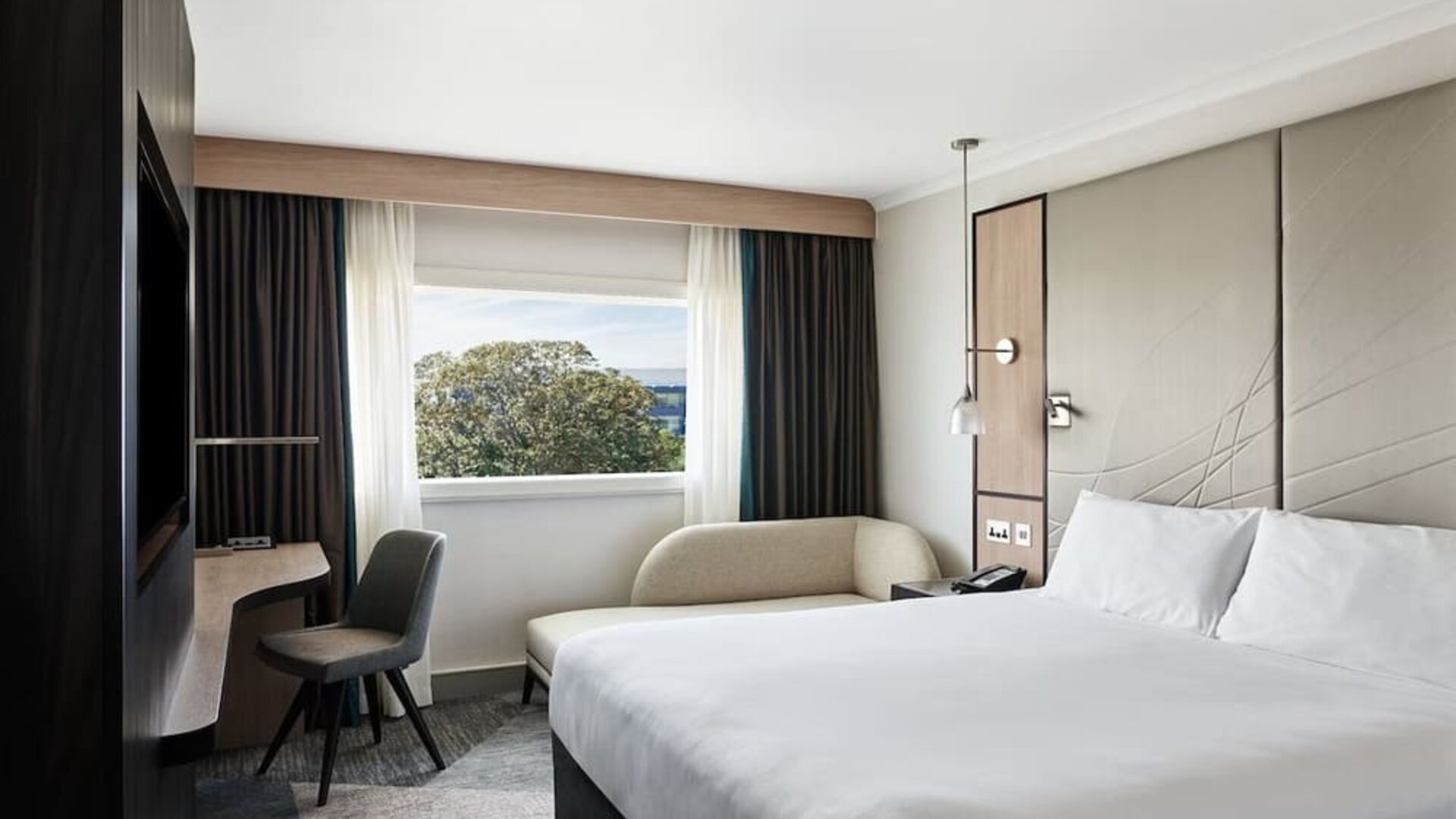 Day use room with work desk and sofa at Hyatt Place London Heathrow Airport.