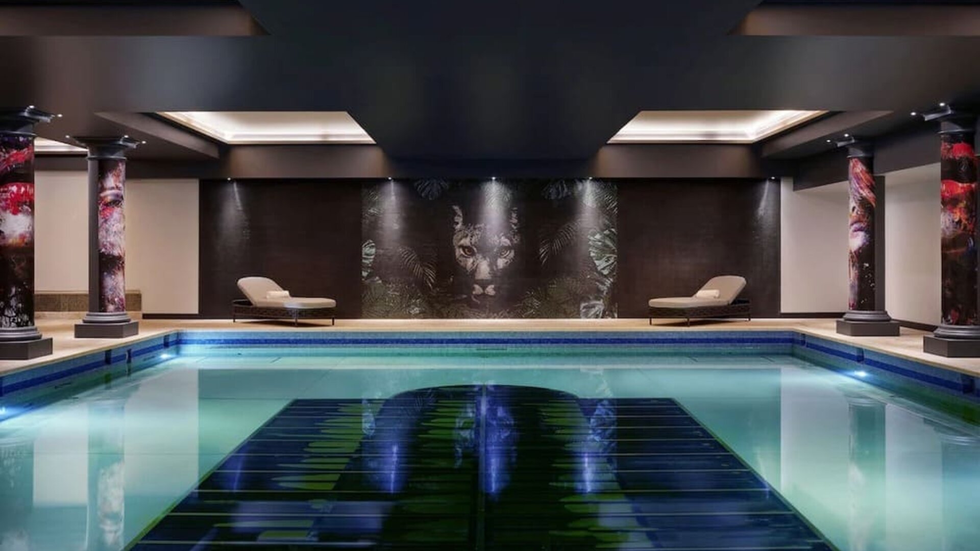 Relaxing indoor pool with lounge chairs at NYX Hotel London Holborn By Leonardo.