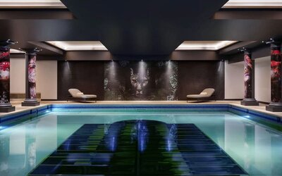 Relaxing indoor pool with lounge chairs at NYX Hotel London Holborn By Leonardo.