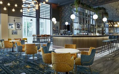 Hotel bar with comfortable seating, perfect for co-working at Leonardo Royal Hotel London Tower Bridge.