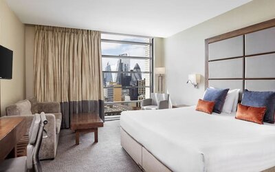 Day use room with TV, work desk and city view at Leonardo Royal Hotel London Tower Bridge.