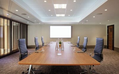 Professional meeting room with ergonomic chairs at Leonardo Royal Hotel London Tower Bridge.