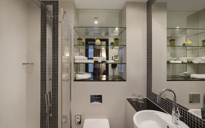 Guest bathroom with shower and free toiletries at Leonardo Royal St Paul's Hotel.