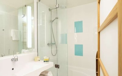 Guest bathroom with shower at Novotel Manchester West.