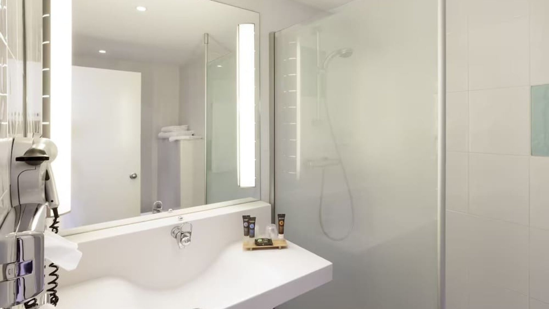 Private guest bathroom with free toiletries at Novotel Manchester West.