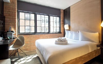 Day use room with large window, work desk and coffee maker at Bloc Hotel Birmingham.