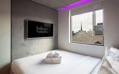 Day use room with TV screen and city view at Bloc Hotel Birmingham.