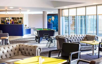 Hotel bar with lounge seating and billiards at Ibis Styles Barnsley.