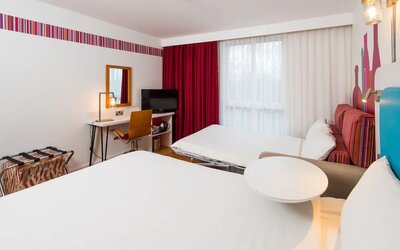 Day use family room with king bed, convertible sofa and work desk at Ibis Styles Barnsley.