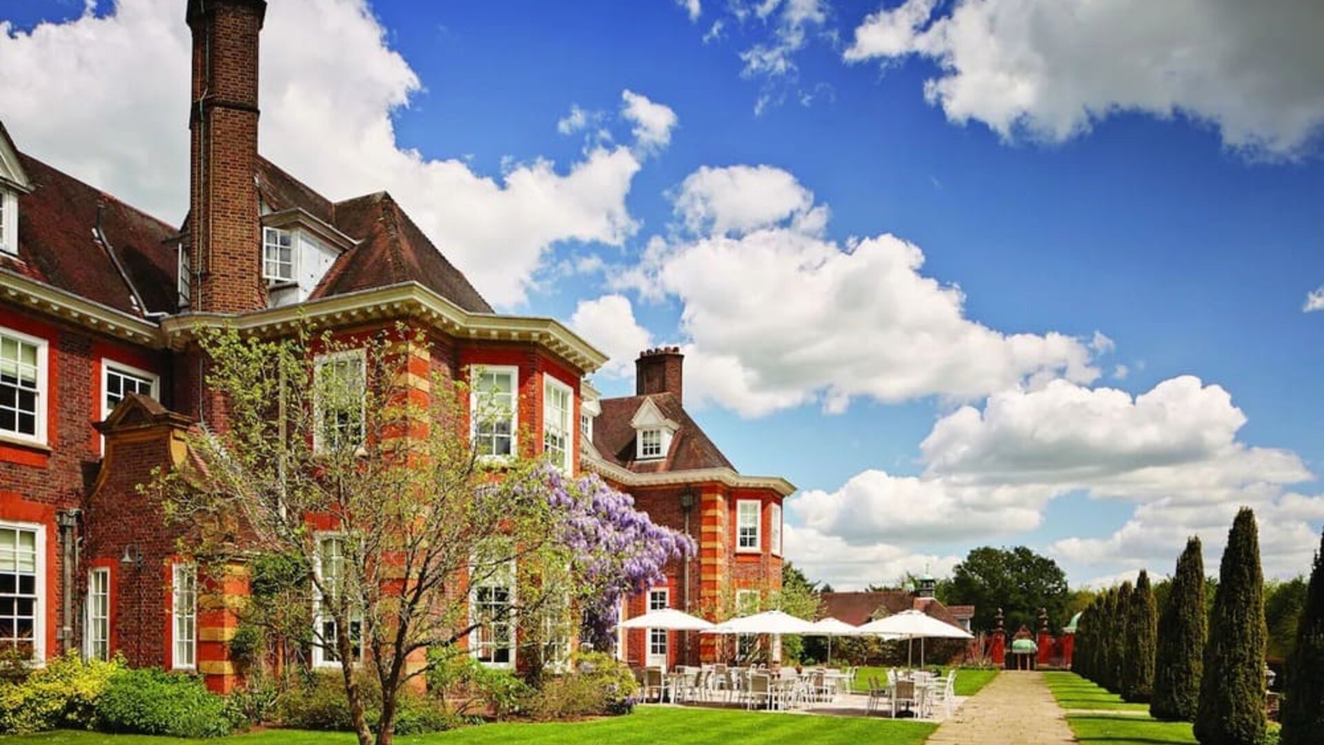 Hotel exterior with lounge seating at Barnett Hill Hotel.