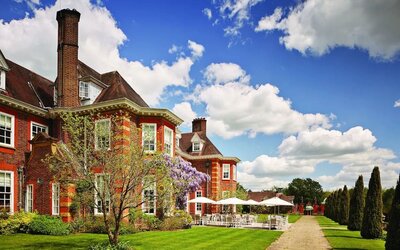 Hotel exterior with lounge seating at Barnett Hill Hotel.