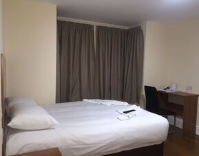 Day use room with king bed and work desk at Buckingham Hotel.