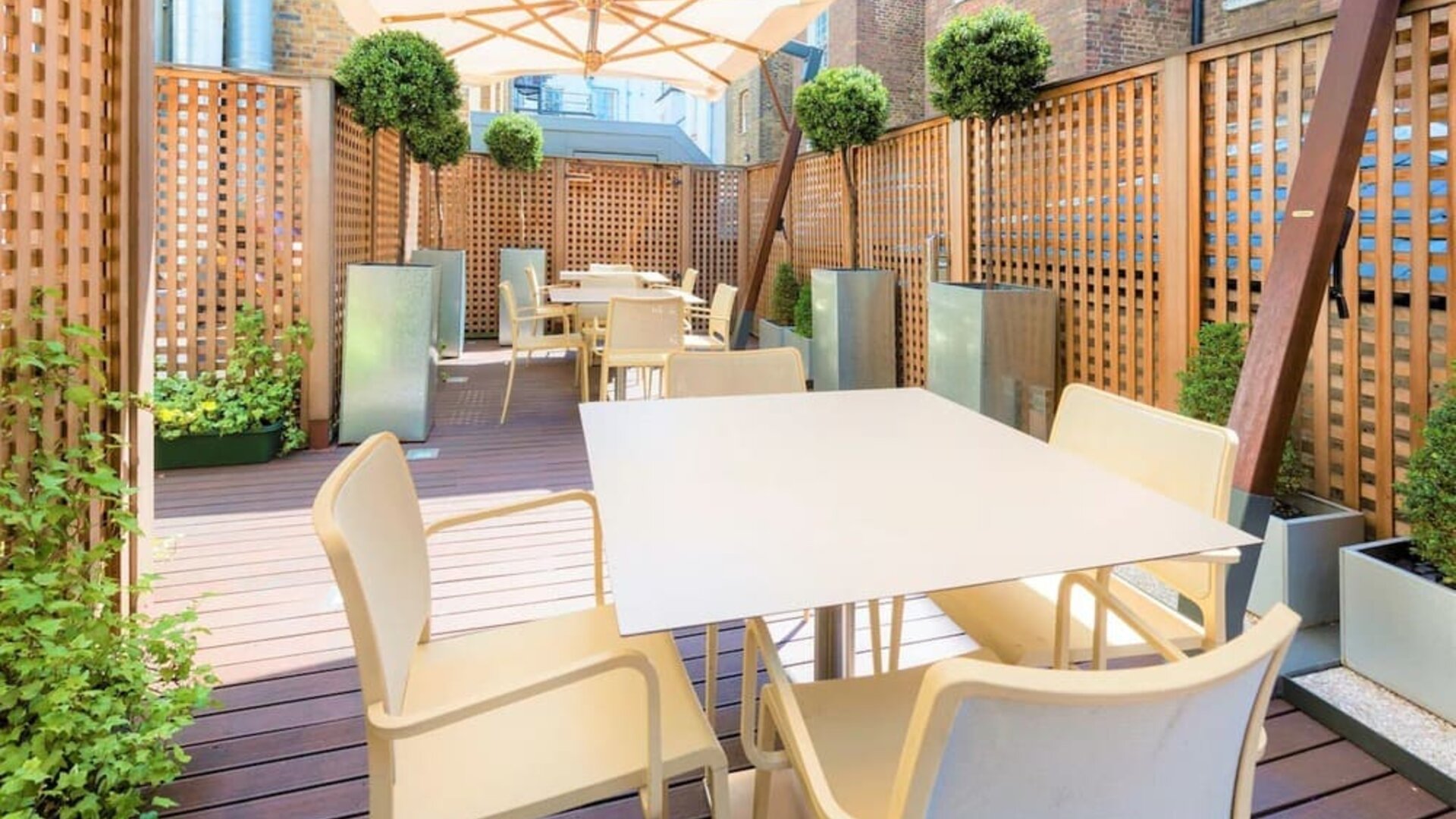 Beautiful outdoor patio with sitting area at Indigo London-Paddington Hotel.