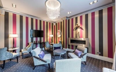 Lounge area with comfortable seating and fireplace at Mercure London Hyde Park Hotel.