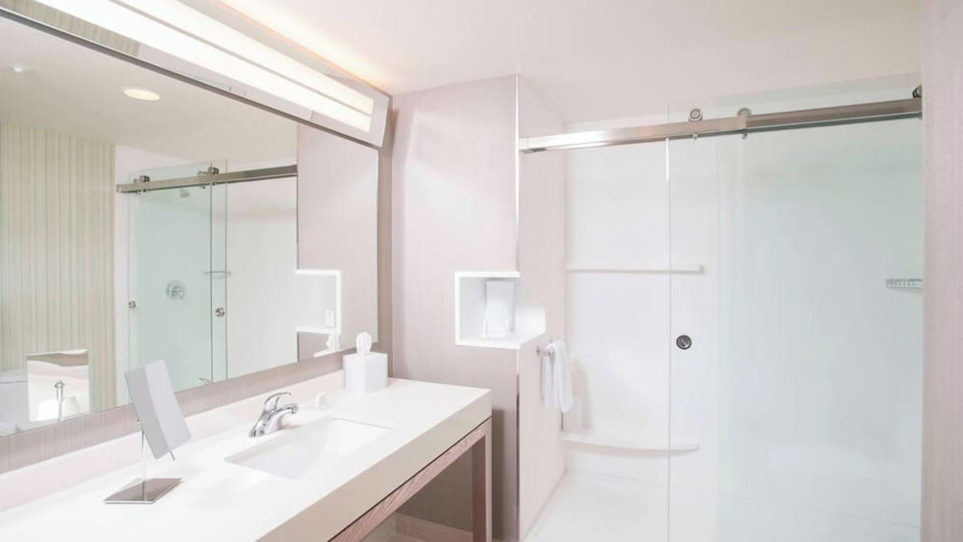 Guest bathroom with shower at Courtyard By Marriott Redwood City.