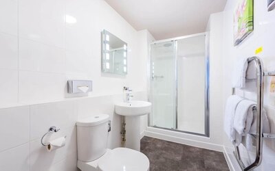 Guest bathroom with shower and free toiletries at Mercure Nottingham City Centre Hotel.