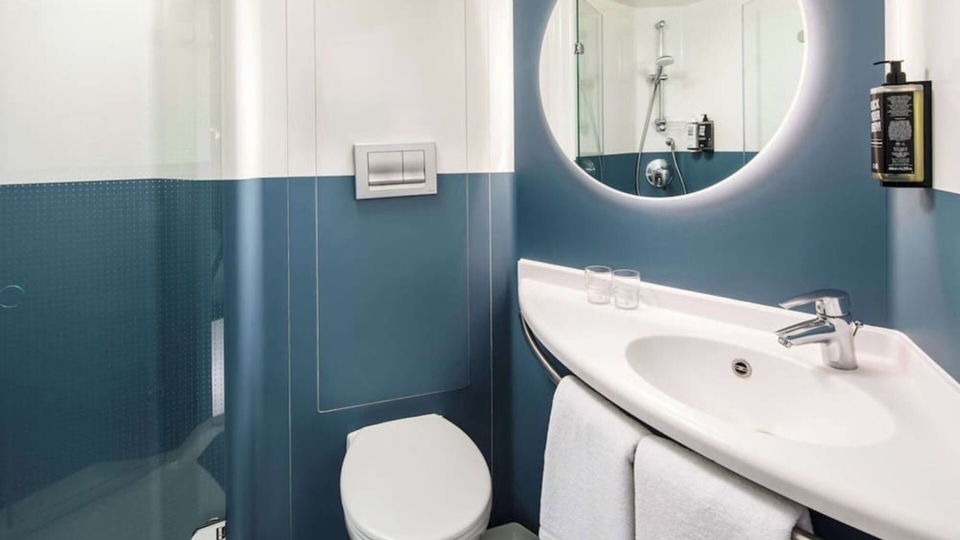 Private guest bathroom with shower and free toiletries at Ibis London Blackfriars Hotel.