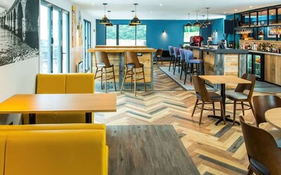 Dining area with comfortable seating, perfect for co-working at Ibis Plymouth.