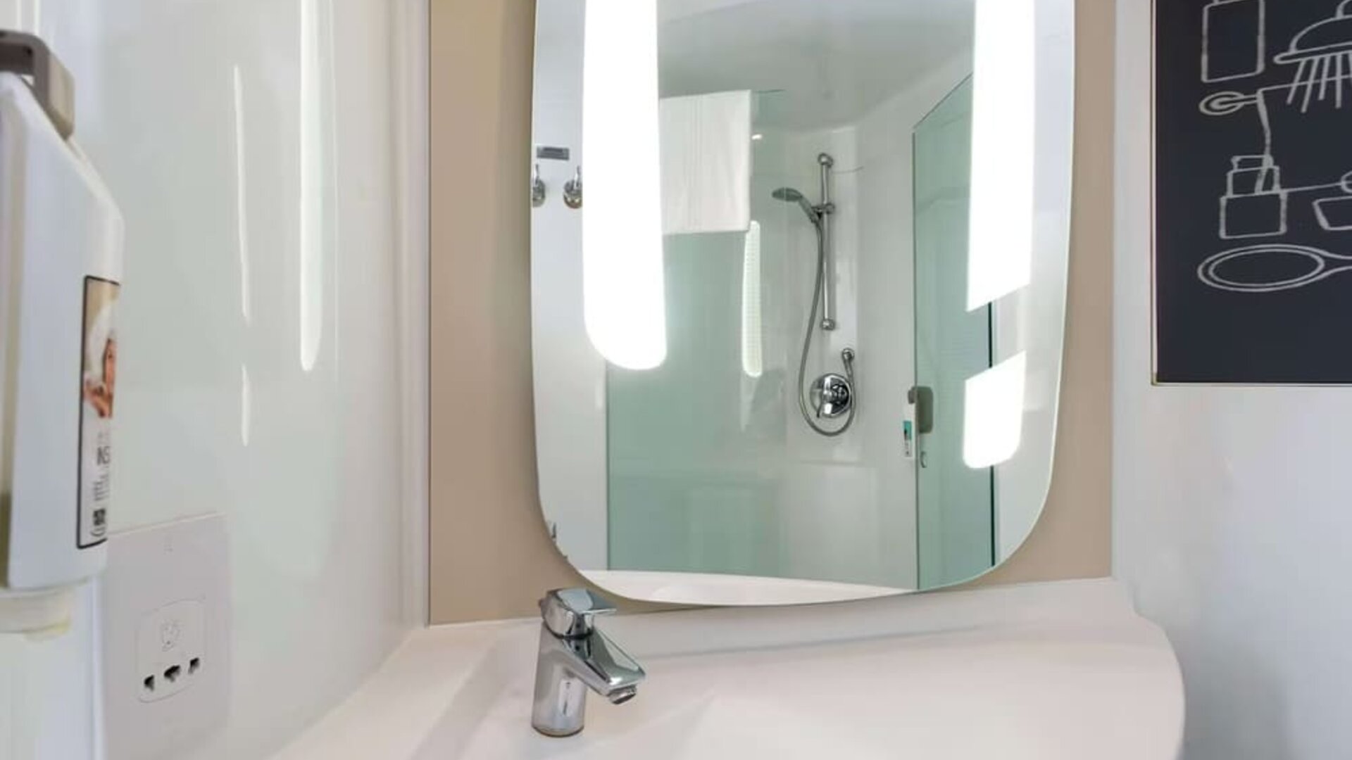 Private guest bathroom with shower at ibis Sheffield City.