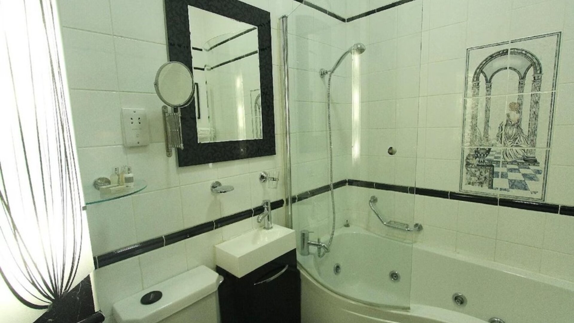Private bathroom with tub and free toiletries at Opulence Central London Hotel.