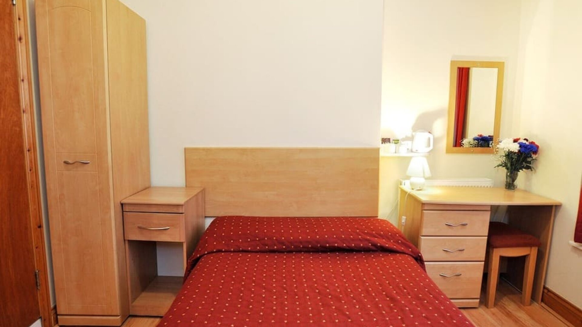 Standard day use room with queen bed and work desk at Elmwood Hotel.