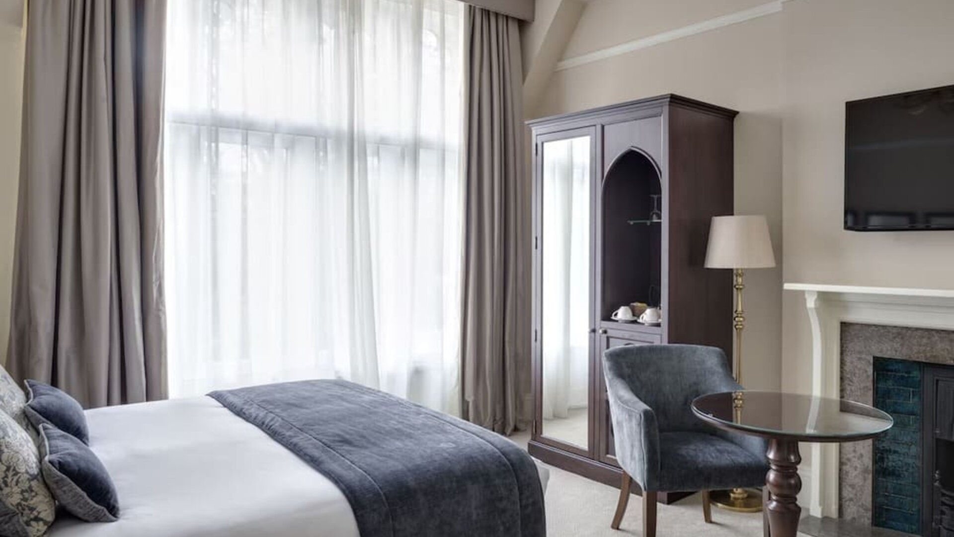 Day use king room with floor to ceiling window, fireplace and workspace at St Paul's Hotel.