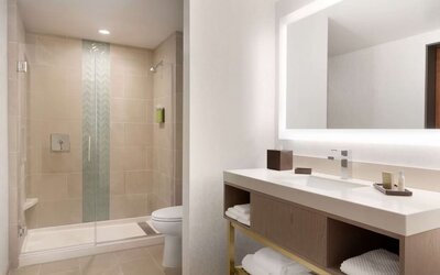 Guest bathroom with shower at Embassy Suites Boulder.
