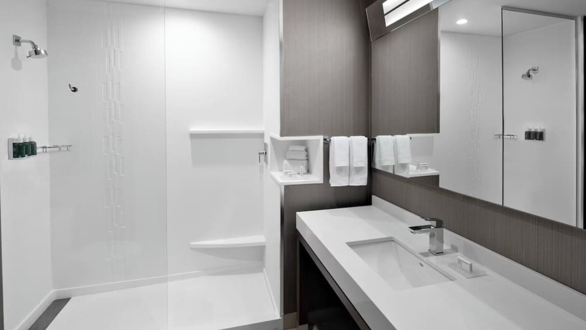 Guest bathroom with shower at Courtyard Delray Beach.
