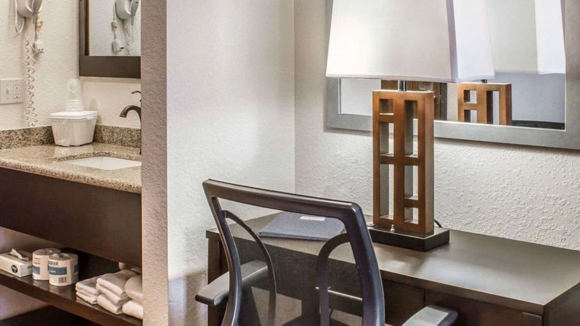 Work desk and guest bathroom at Rodeway Inn Milford.